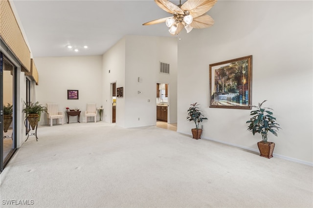 interior space featuring visible vents, carpet floors, recessed lighting, a high ceiling, and a ceiling fan