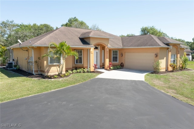 single story home featuring a front yard, an attached garage, central AC, stucco siding, and aphalt driveway