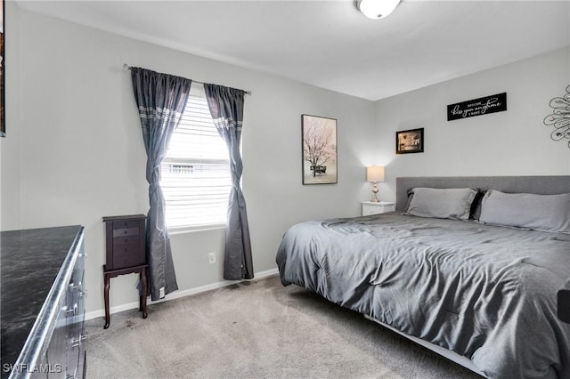 carpeted bedroom featuring baseboards