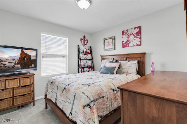 carpeted bedroom featuring baseboards