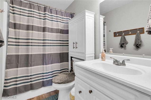 bathroom with toilet, vanity, and shower / tub combo with curtain