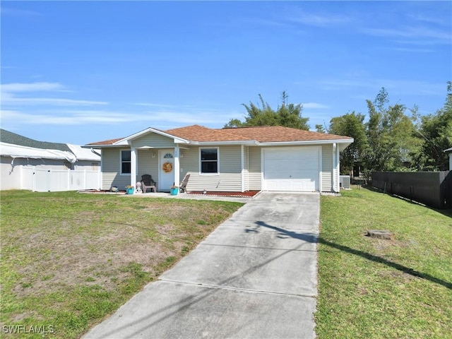 view of front facade with a garage, driveway, a front yard, and fence