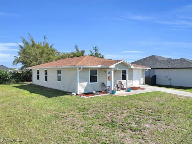 view of front facade featuring a front yard, concrete driveway, and a garage