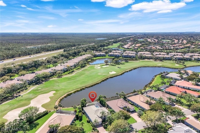 birds eye view of property featuring golf course view, a water view, and a residential view