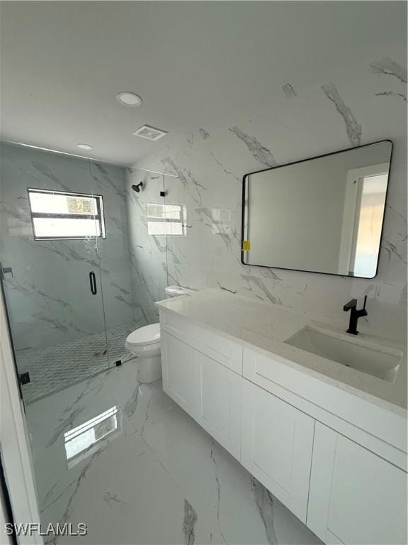 bathroom featuring vanity, a marble finish shower, tile walls, toilet, and marble finish floor