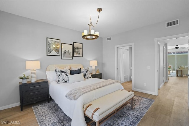 bedroom with light wood-type flooring, visible vents, and baseboards