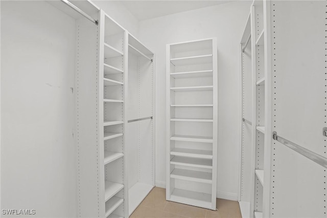 spacious closet with tile patterned floors