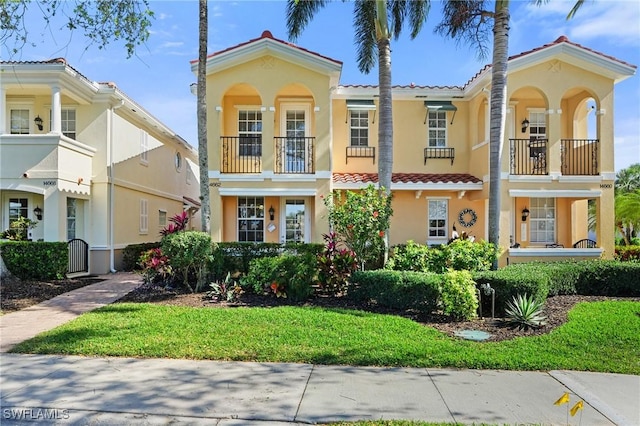 mediterranean / spanish-style home featuring a tile roof and stucco siding