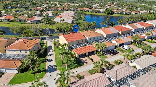 drone / aerial view with a residential view and a water view