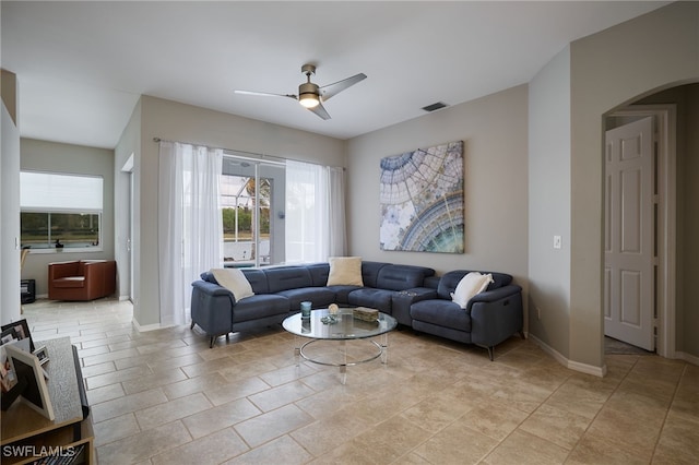 3381 Mystic River Dr, Naples, FL 34120 - living room featuring visible vents, arched walkways, baseboards, and ceiling fan