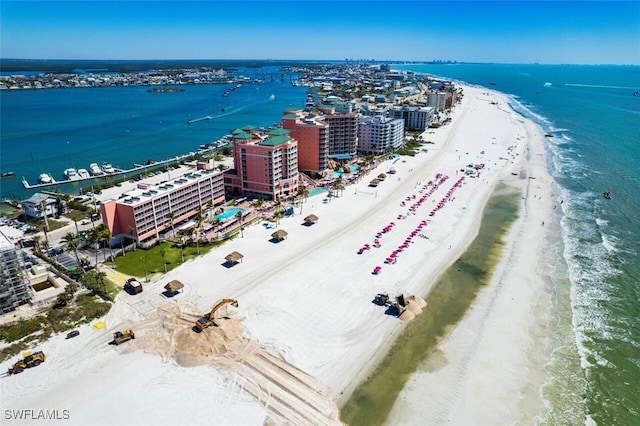 aerial view featuring a water view, a view of city, and a beach view