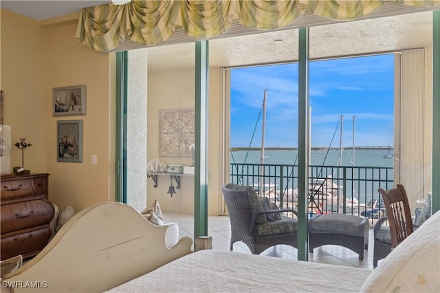 tiled bedroom featuring floor to ceiling windows and a water view