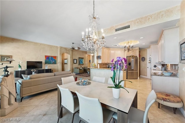 dining room with visible vents, ceiling fan with notable chandelier, recessed lighting, arched walkways, and light tile patterned floors