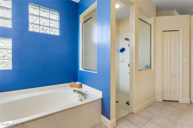12922 Kedleston Cir, Fort Myers, FL 33912 - bathroom with a shower stall, a bath, tile patterned floors, and baseboards