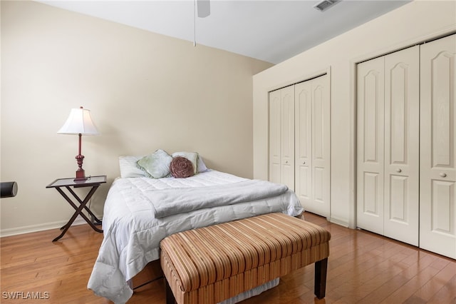 12922 Kedleston Cir, Fort Myers, FL 33912 - bedroom featuring hardwood / wood-style flooring, multiple closets, baseboards, and a ceiling fan