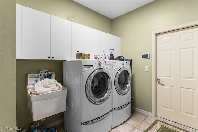 12922 Kedleston Cir, Fort Myers, FL 33912 - laundry room featuring cabinet space, independent washer and dryer, and light tile patterned floors