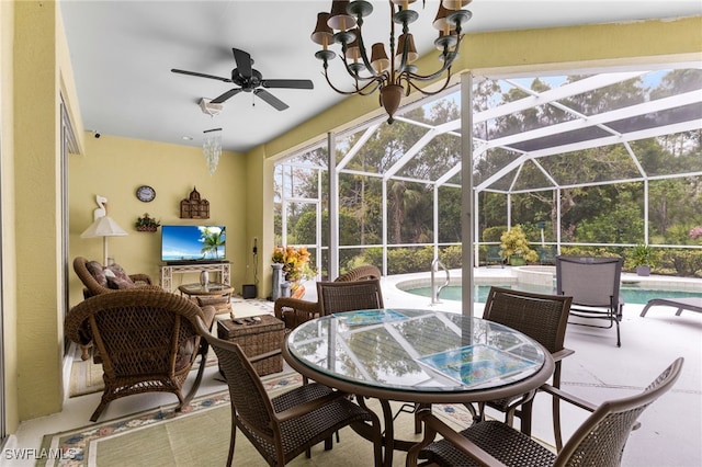12922 Kedleston Cir, Fort Myers, FL 33912 - view of patio with an outdoor pool, glass enclosure, a ceiling fan, and outdoor dining space