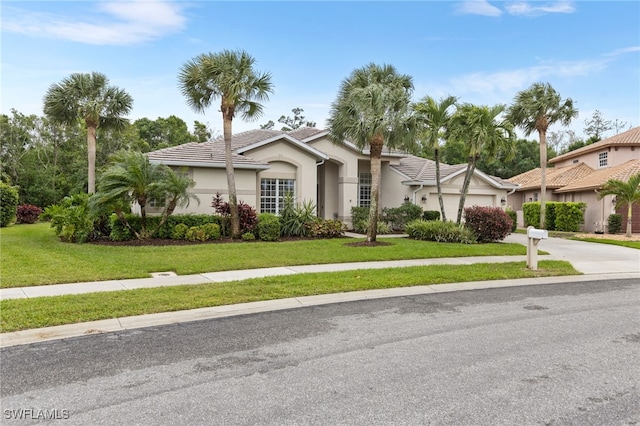 12922 Kedleston Cir, Fort Myers, FL 33912 - ranch-style house with a garage, concrete driveway, stucco siding, and a front yard