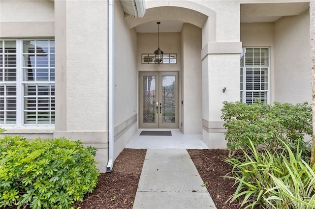 12922 Kedleston Cir, Fort Myers, FL 33912 - view of exterior entry with french doors and stucco siding