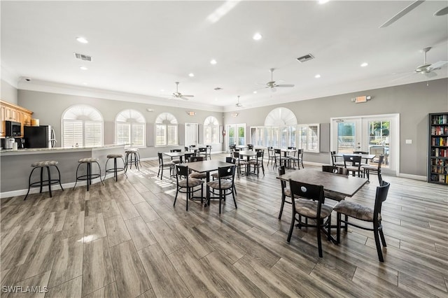 12922 Kedleston Cir, Fort Myers, FL 33912 - dining room featuring a ceiling fan, crown molding, light wood finished floors, recessed lighting, and baseboards