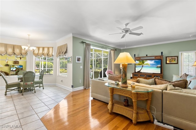 12922 Kedleston Cir, Fort Myers, FL 33912 - living area featuring a chandelier, a ceiling fan, healthy amount of natural light, tile patterned flooring, and ornamental molding