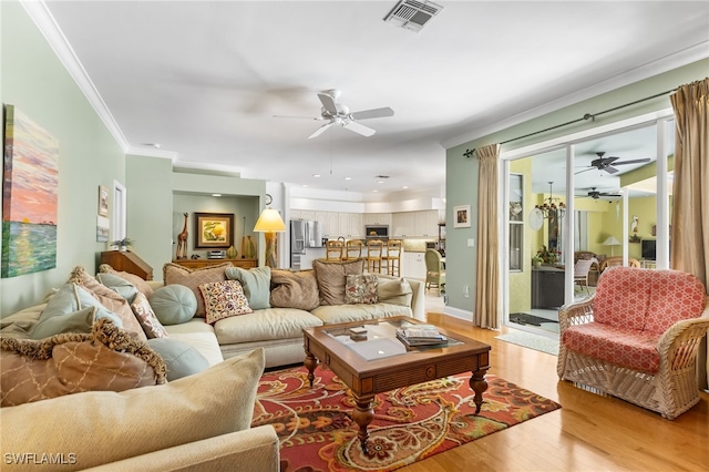 12922 Kedleston Cir, Fort Myers, FL 33912 - living room with a ceiling fan, light wood-type flooring, and ornamental molding