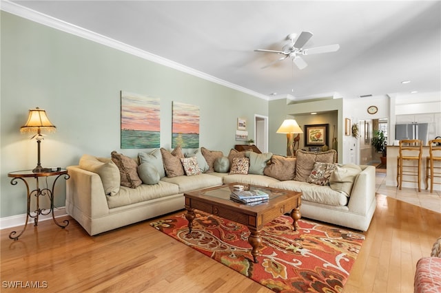 12922 Kedleston Cir, Fort Myers, FL 33912 - living room with light wood-type flooring, a ceiling fan, crown molding, and baseboards