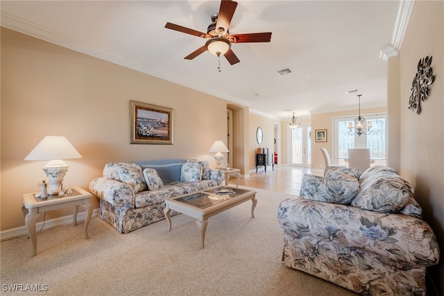 living room with visible vents, ornamental molding, ceiling fan with notable chandelier, carpet flooring, and baseboards