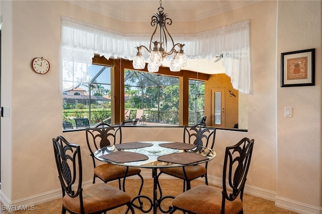 dining room featuring crown molding, a notable chandelier, and baseboards