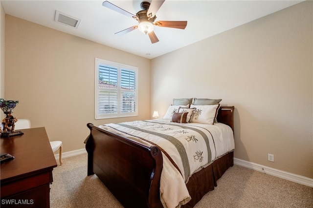 bedroom with a ceiling fan, baseboards, visible vents, and light carpet