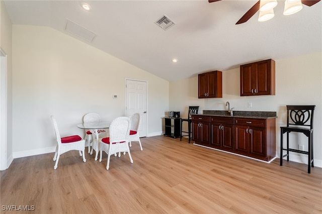 kitchen with visible vents, ceiling fan, light wood-type flooring, lofted ceiling, and a sink