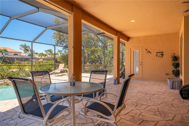 view of patio / terrace featuring glass enclosure and outdoor dining space