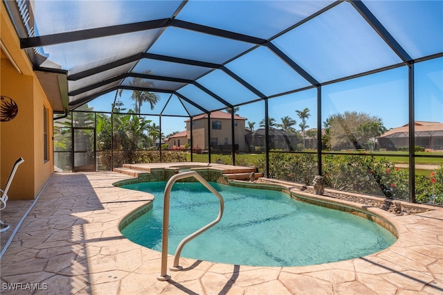 view of pool with a patio, a lanai, and a pool with connected hot tub