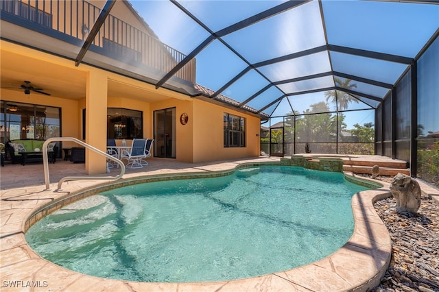 view of pool featuring a lanai, a pool with connected hot tub, a ceiling fan, and a patio