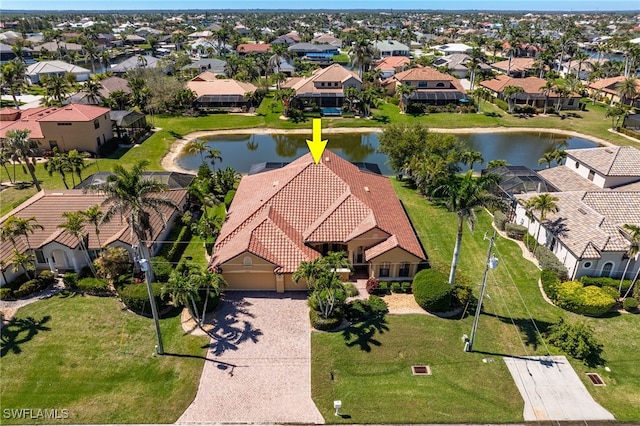 drone / aerial view featuring a residential view and a water view