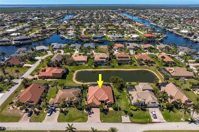 bird's eye view with a residential view and a water view