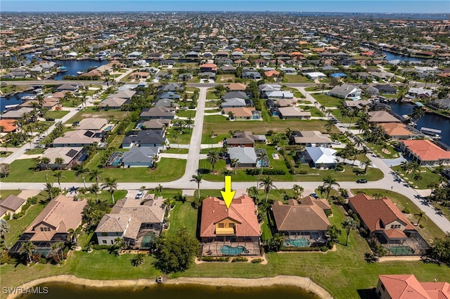 birds eye view of property with a residential view and a water view