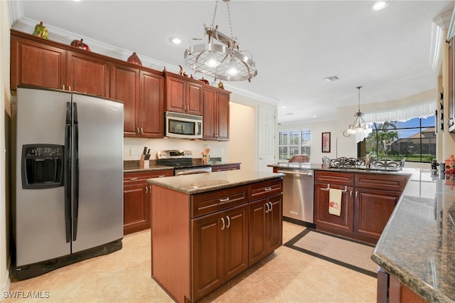 5220 SW 22nd Ave, Cape Coral, FL 33914 - kitchen featuring appliances with stainless steel finishes, crown molding, pendant lighting, recessed lighting, and a peninsula