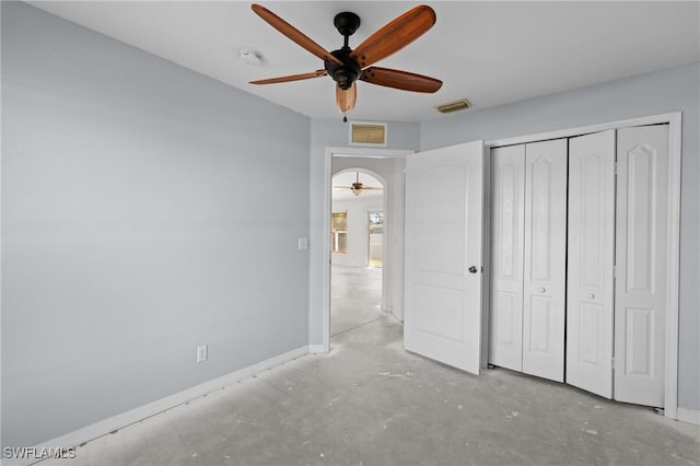 unfurnished bedroom with visible vents, baseboards, concrete flooring, and a closet