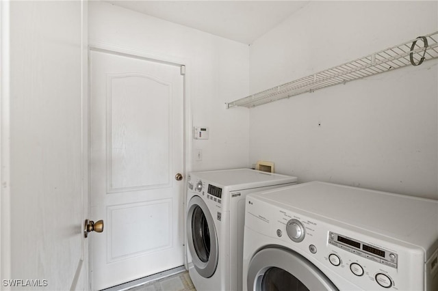 washroom with washing machine and dryer and laundry area