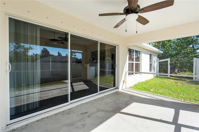 unfurnished sunroom featuring ceiling fan