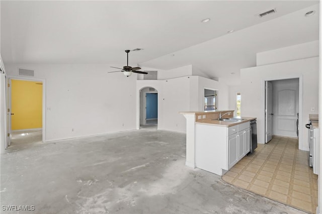 kitchen with a sink, visible vents, open floor plan, and vaulted ceiling