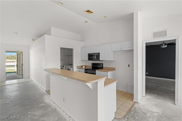 kitchen featuring washer and clothes dryer, electric range, light countertops, and visible vents