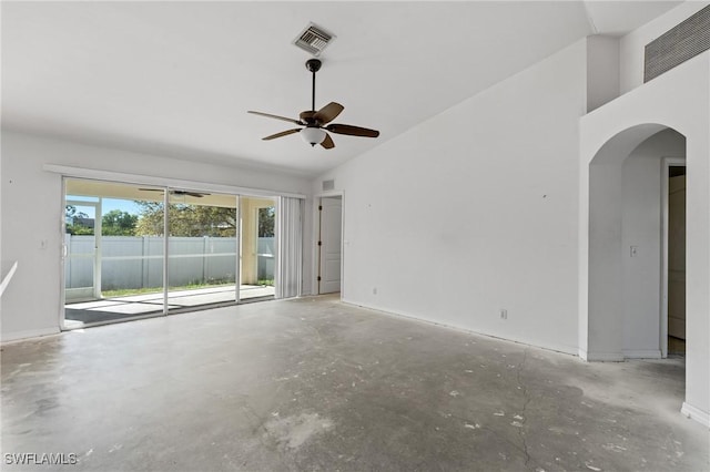 spare room featuring visible vents, arched walkways, unfinished concrete floors, and a ceiling fan