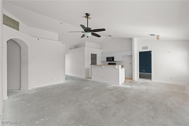 unfurnished living room featuring visible vents, arched walkways, and ceiling fan