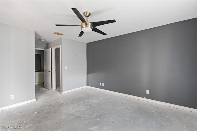 interior space featuring unfinished concrete flooring, a ceiling fan, visible vents, and baseboards