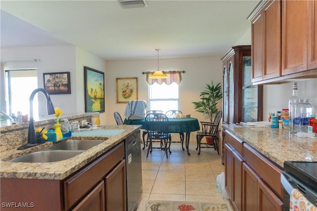 kitchen featuring visible vents, a sink, light tile patterned floors, dishwasher, and hanging light fixtures