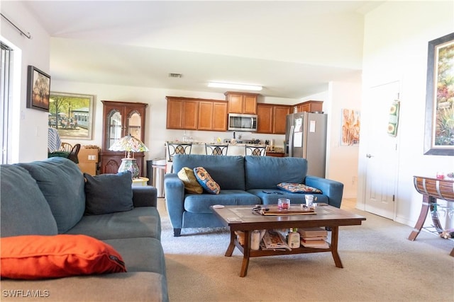 living area featuring light colored carpet and visible vents