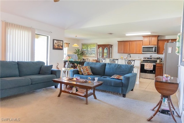 living room featuring visible vents, light colored carpet, and vaulted ceiling