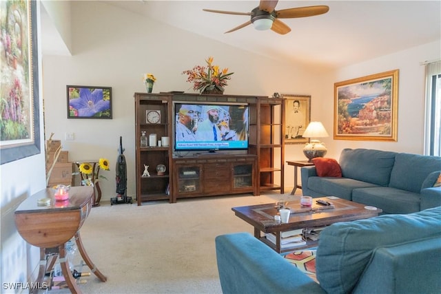 living area featuring carpet floors, a ceiling fan, and vaulted ceiling